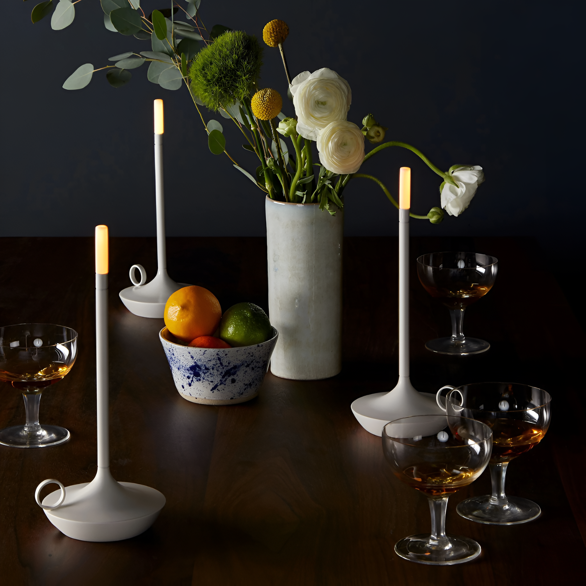 Minimalist lights on table with vase and fruits