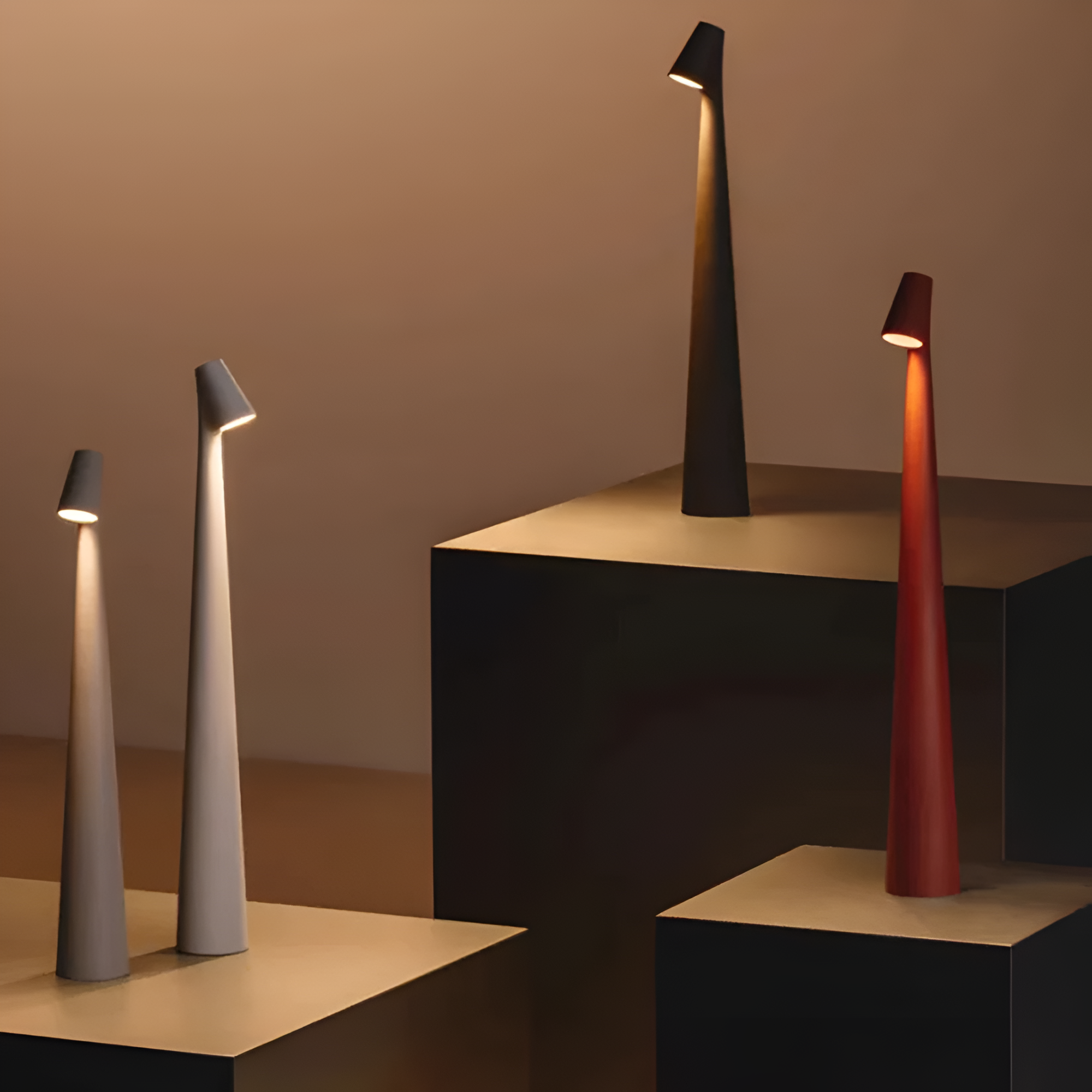 Modern table lamps in various colors on geometric platforms against a warm-toned background