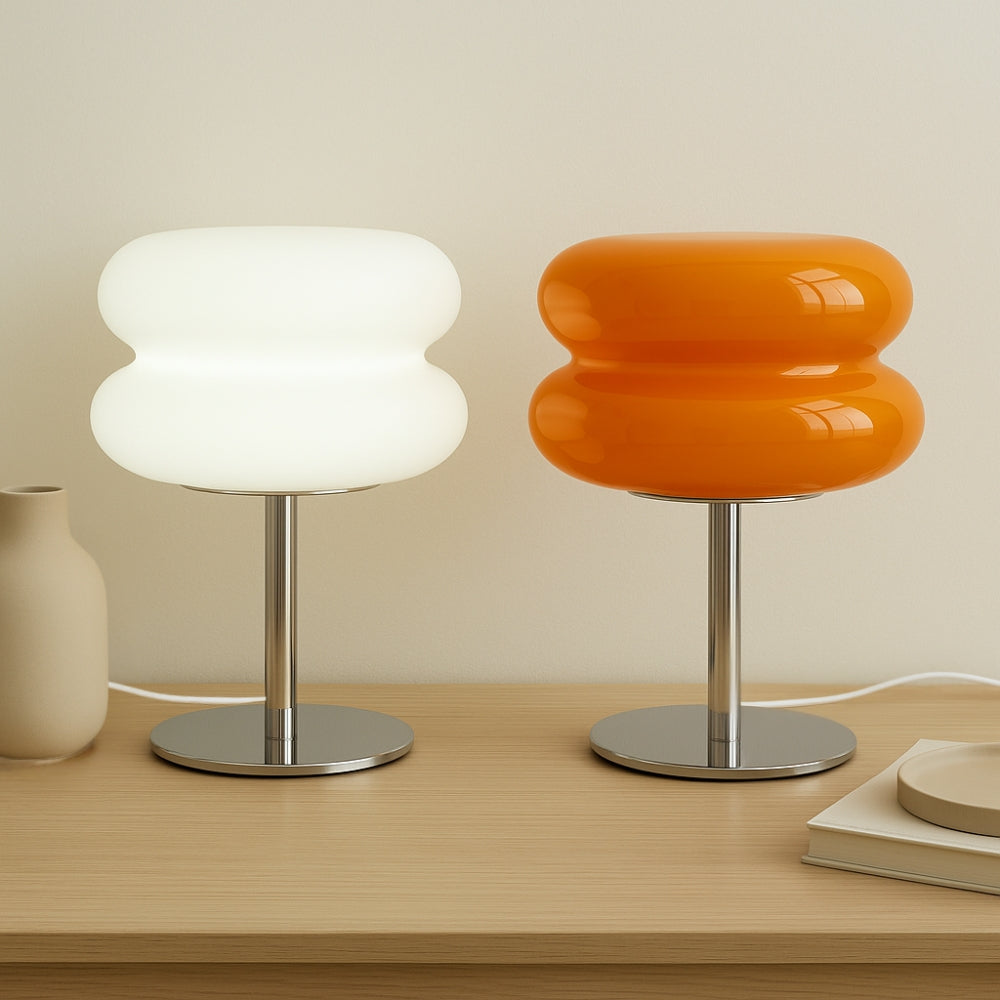 Two modern stools with unique designs on a wooden surface.