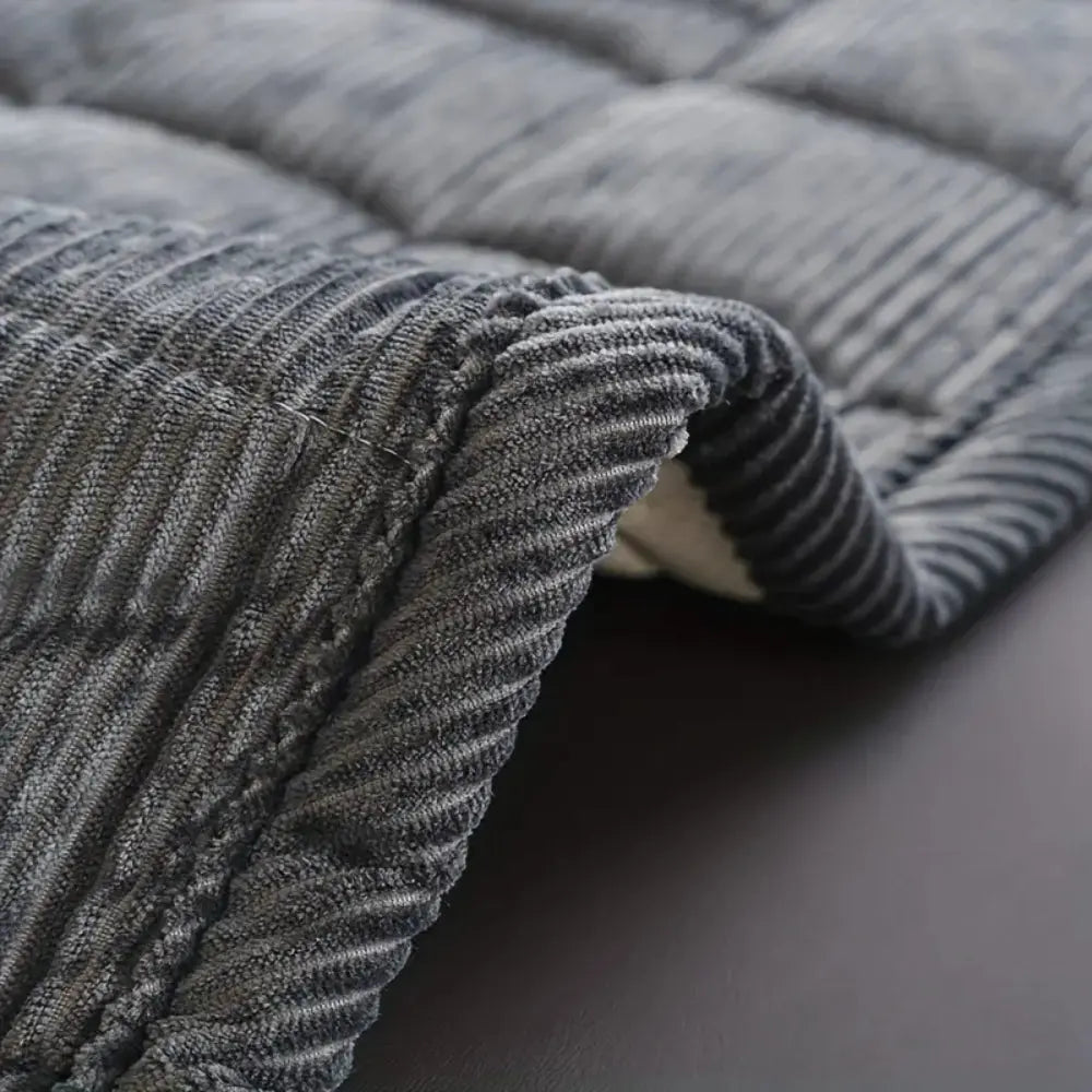 Close-up of a textured gray blanket on a dark surface