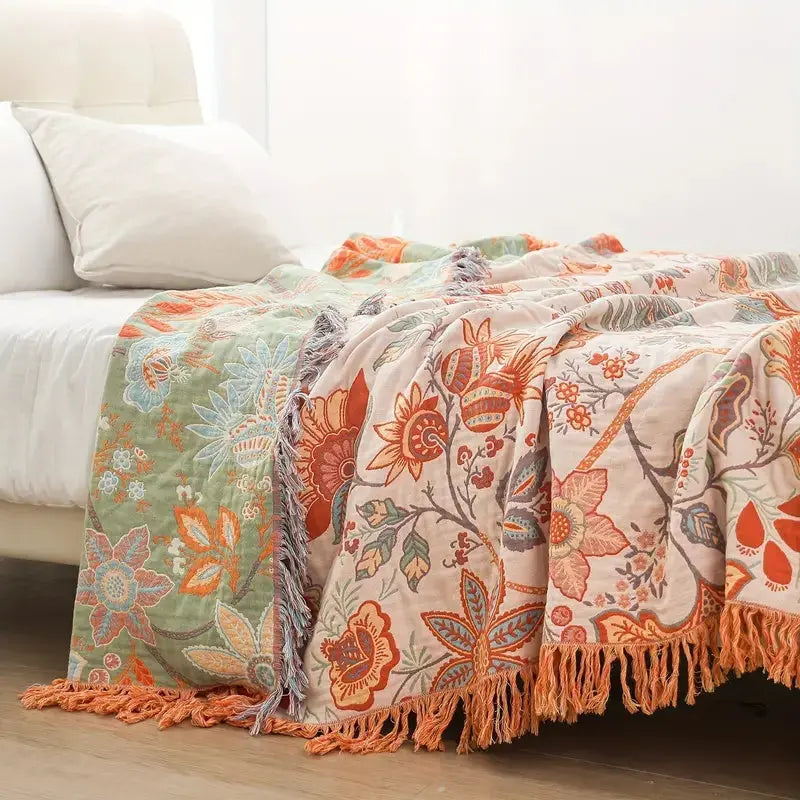 Floral patterned blanket with tassels on a white sofa