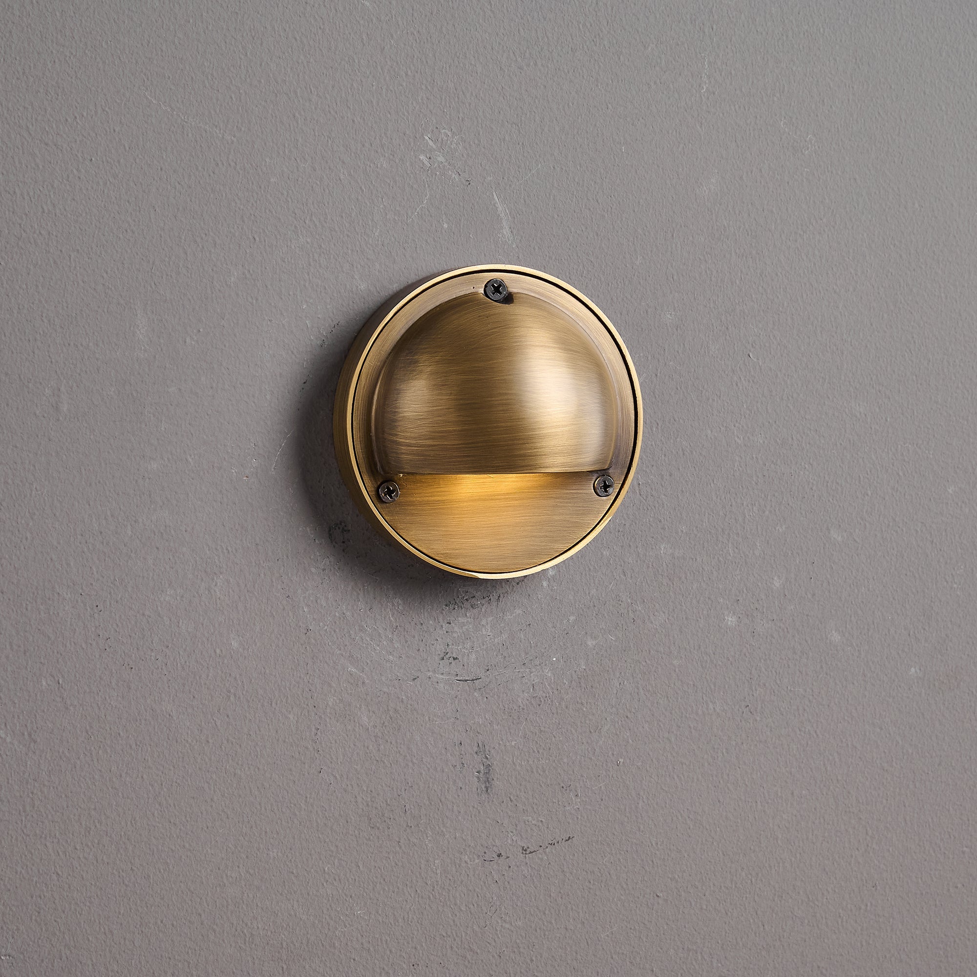 Round Brass Wall Sconce with Shielded Glow