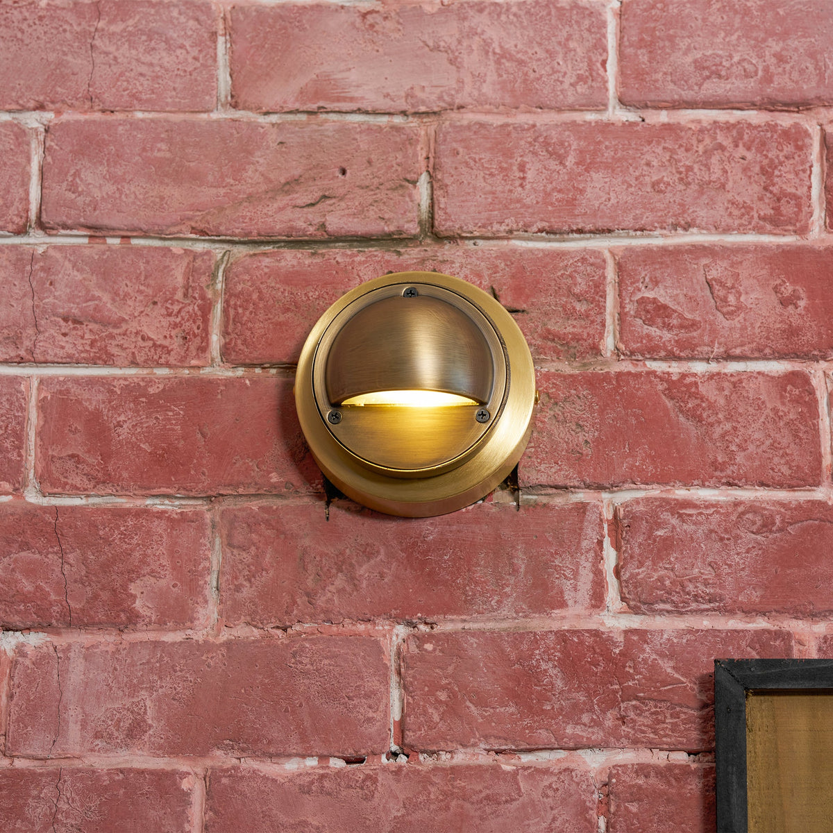 Round Brass Wall Sconce with Shielded Glow