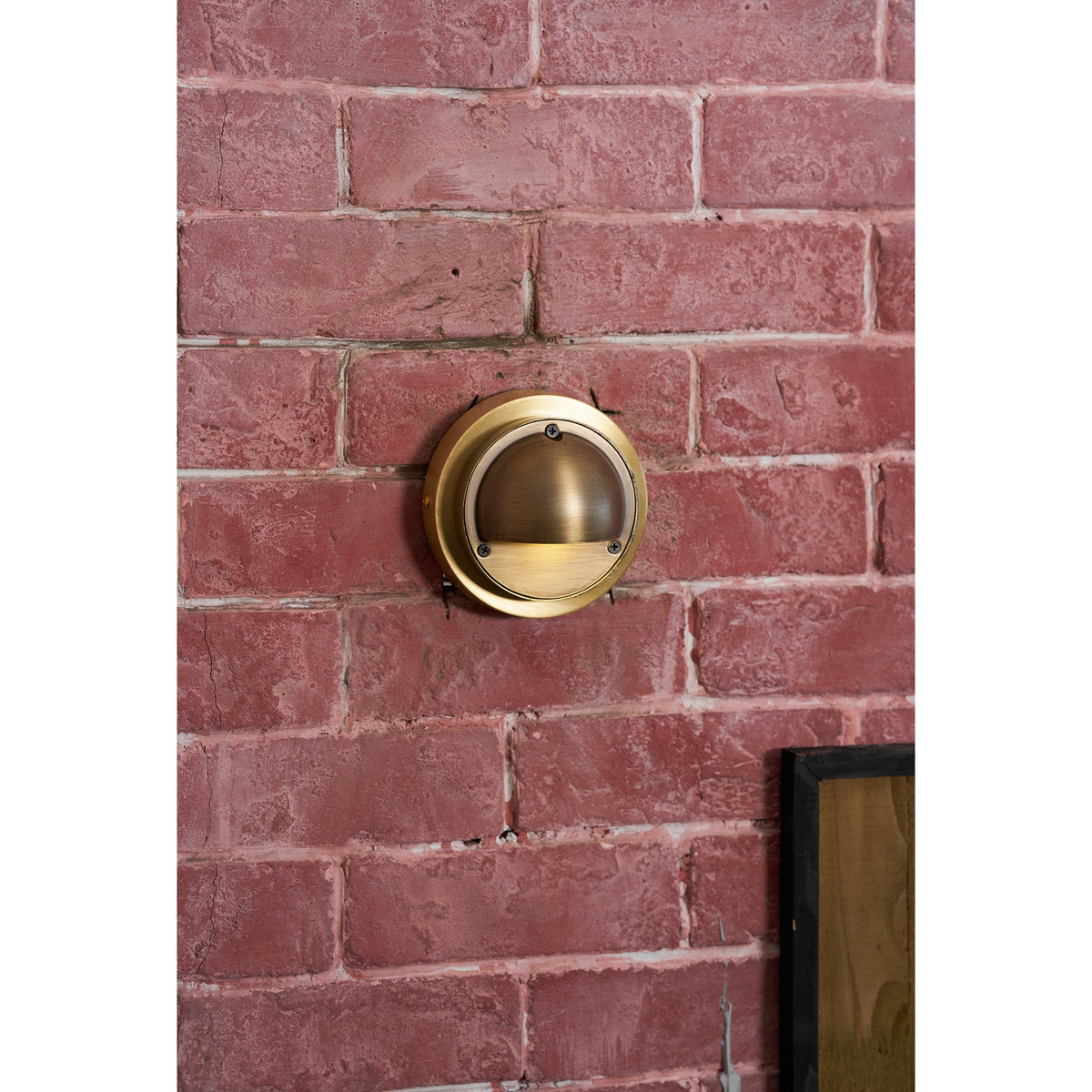 Round Brass Wall Sconce with Shielded Glow