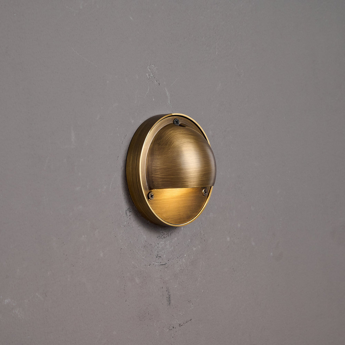 Round Brass Wall Sconce with Shielded Glow