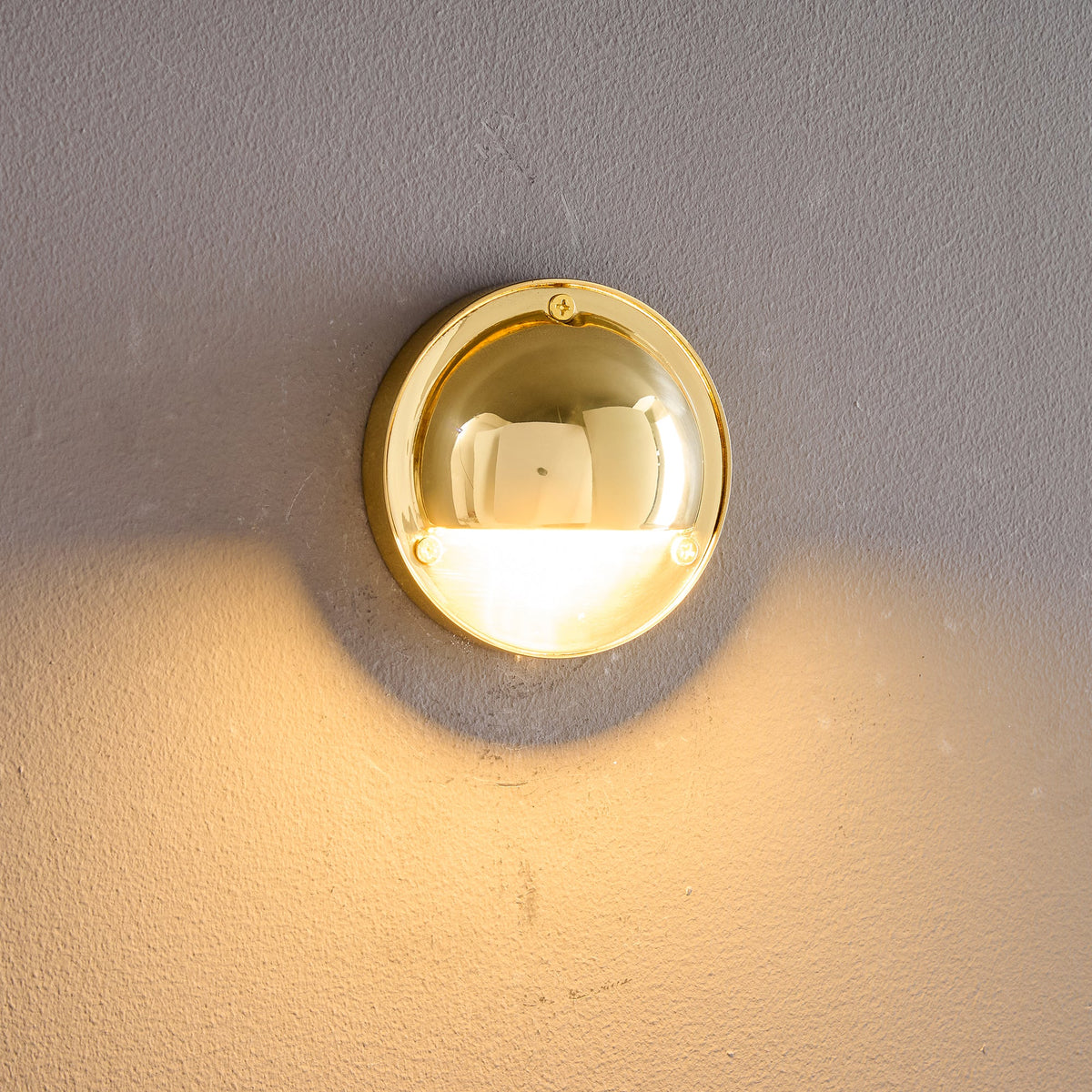 Round Brass Wall Sconce with Shielded Glow