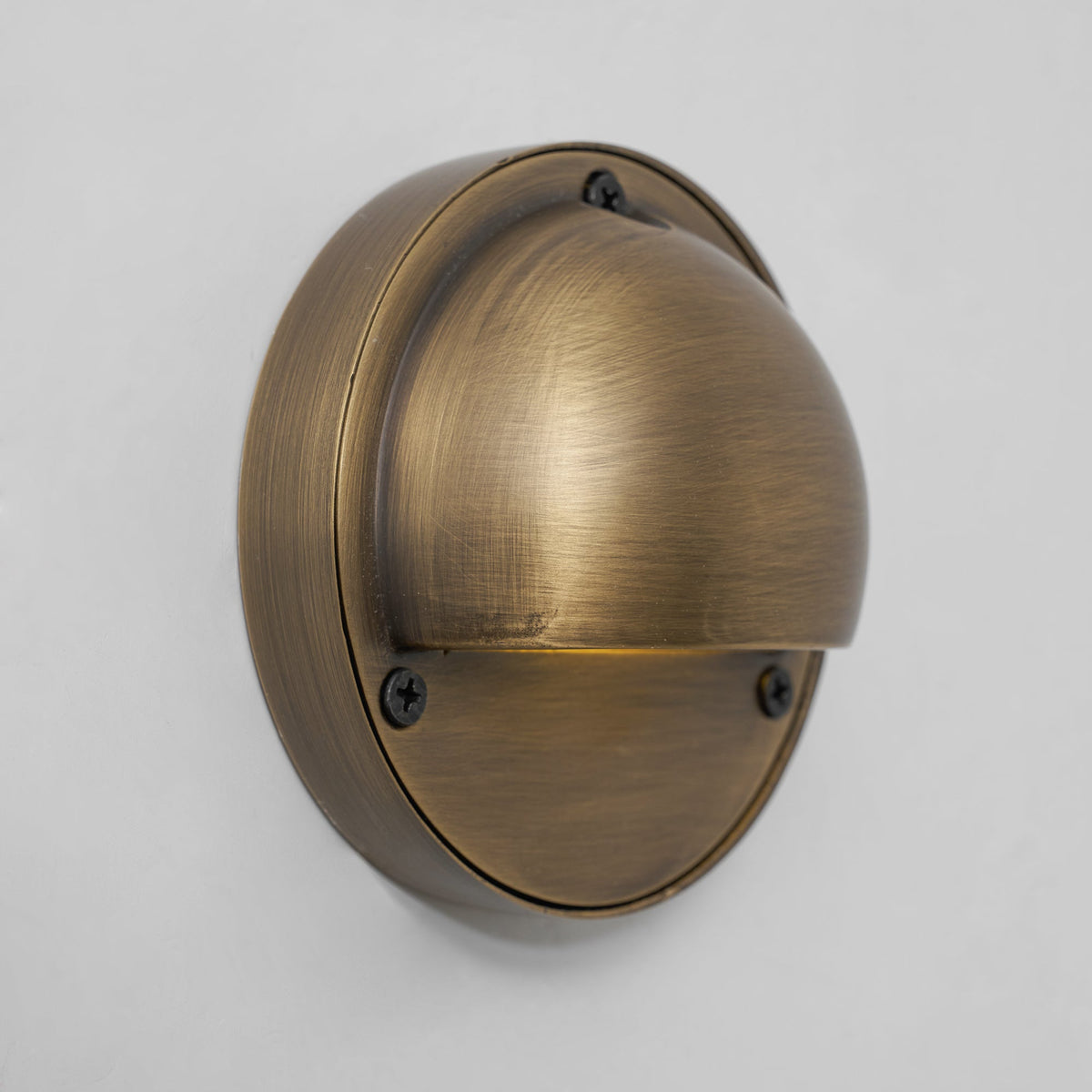 Round Brass Wall Sconce with Shielded Glow