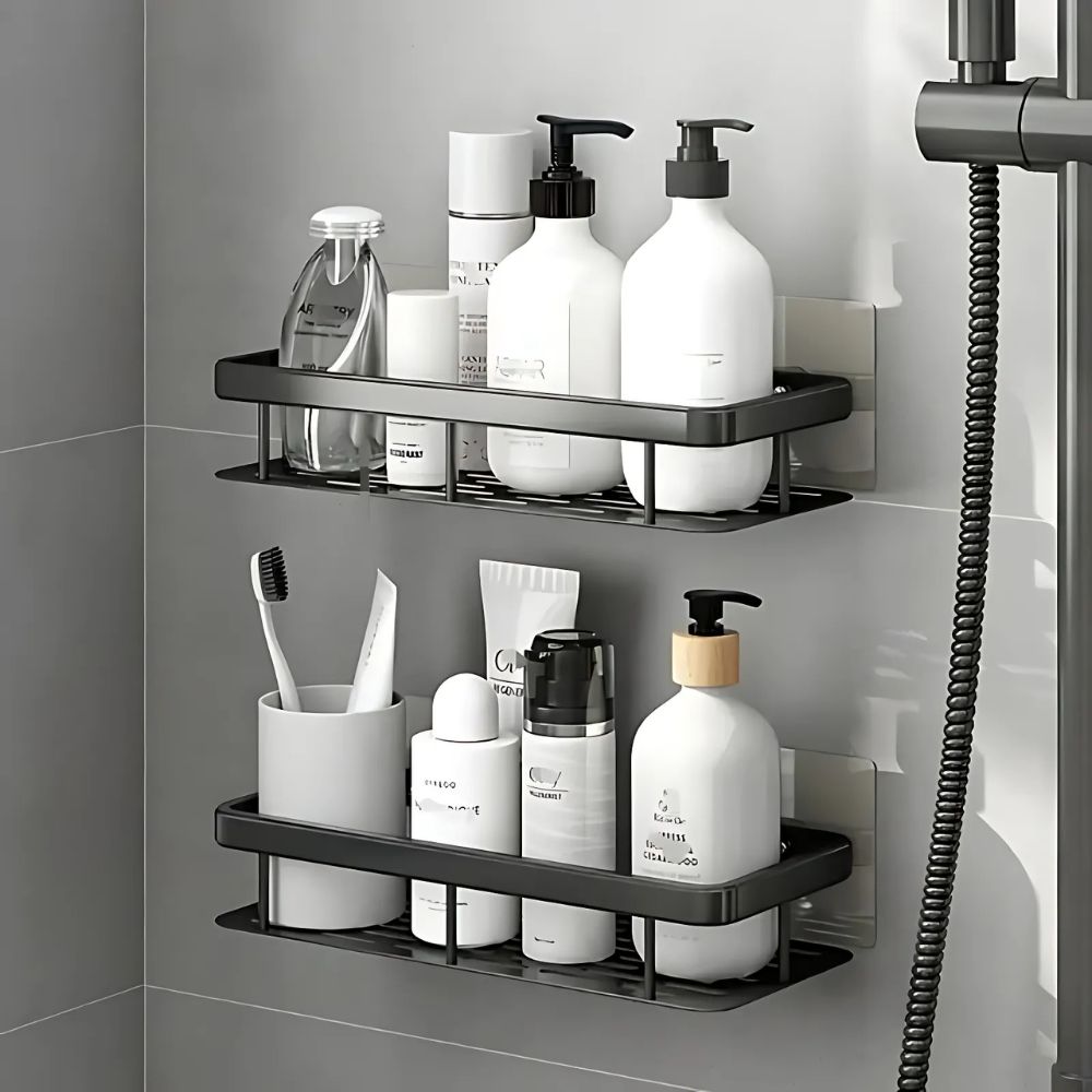 Shower caddy with various toiletries on a gray tiled wall.