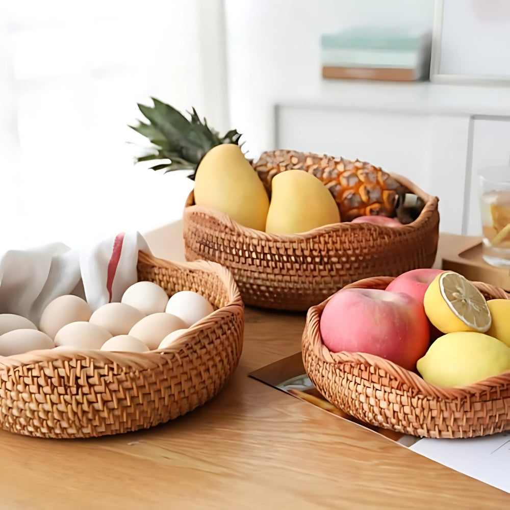 Wicker baskets containing eggs, fruit, and vegetables on a wooden surface.