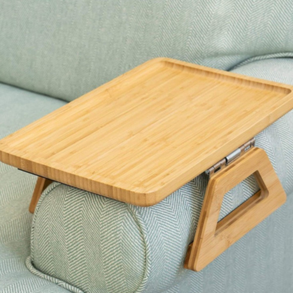 Wooden tray table on a green sofa