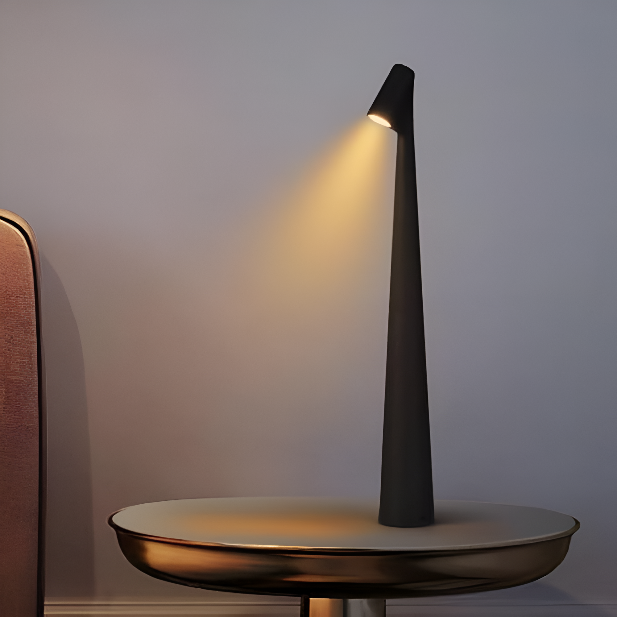 Modern black table lamp on a white surface with a neutral background