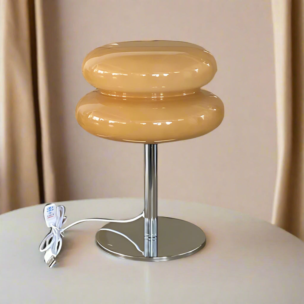 Modern beige stool with a metallic base on a neutral background