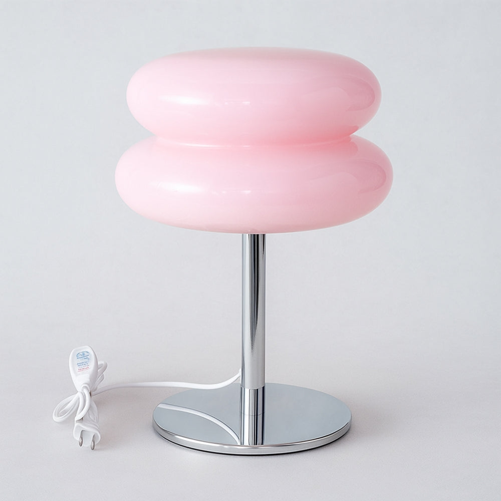 Pink table lamp with a silver base on a white background