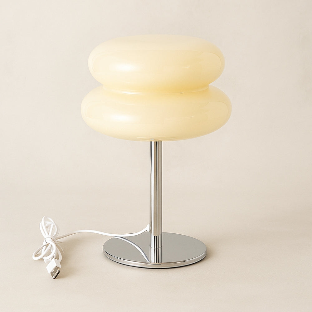 Modern table lamp with two stacked lampshades on a beige background