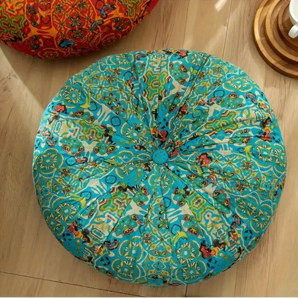 Round blue patterned cushion on a wooden floor