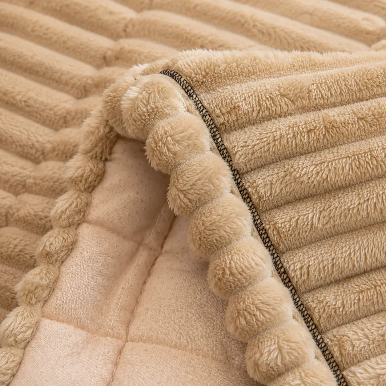 Close-up of a beige textured fabric with a ribbed pattern
