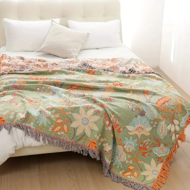 Floral patterned blanket on a bed with white pillows