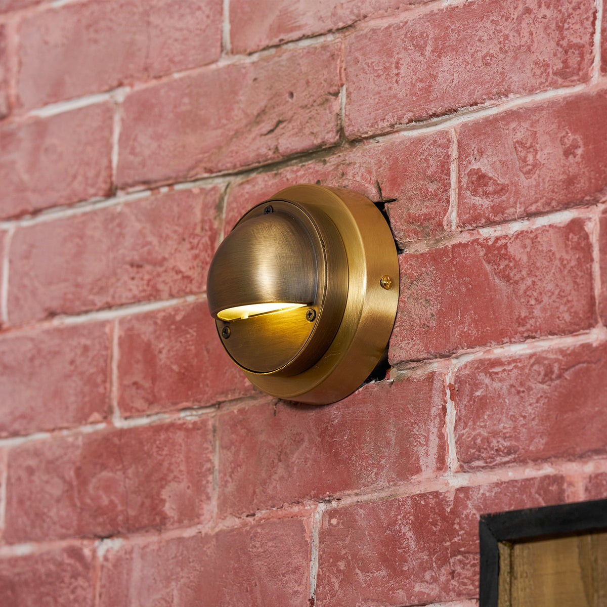 Round Brass Wall Sconce with Shielded Glow