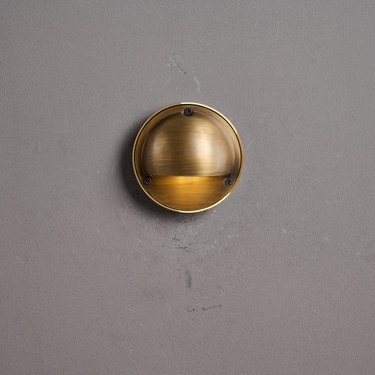 Round Brass Wall Sconce with Shielded Glow