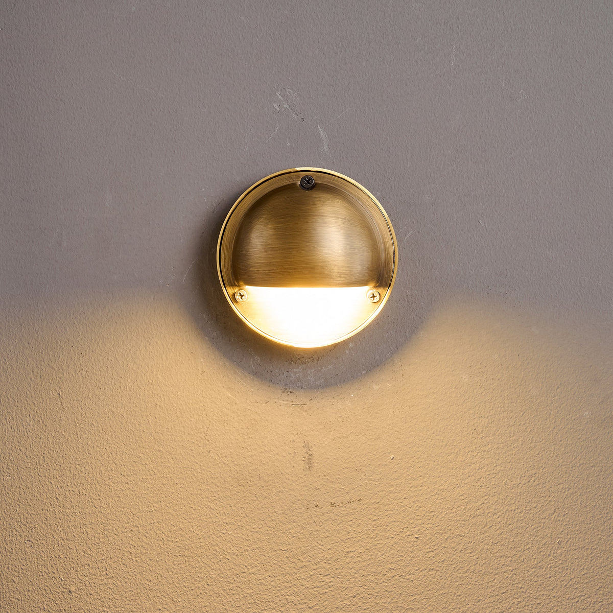 Round Brass Wall Sconce with Shielded Glow