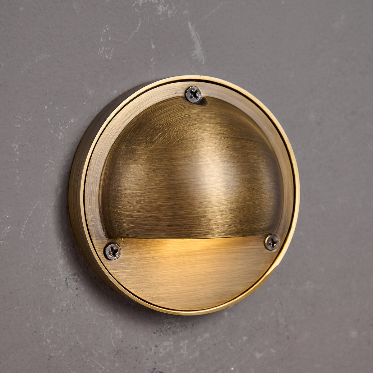 Round Brass Wall Sconce with Shielded Glow