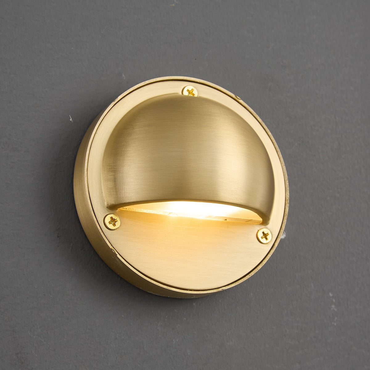 Round Brass Wall Sconce with Shielded Glow