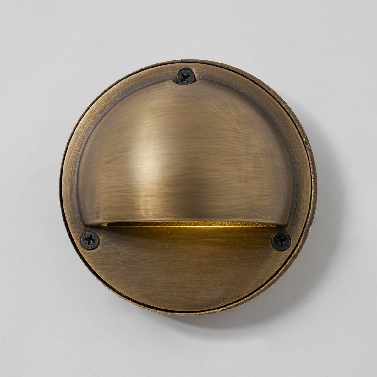 Round Brass Wall Sconce with Shielded Glow
