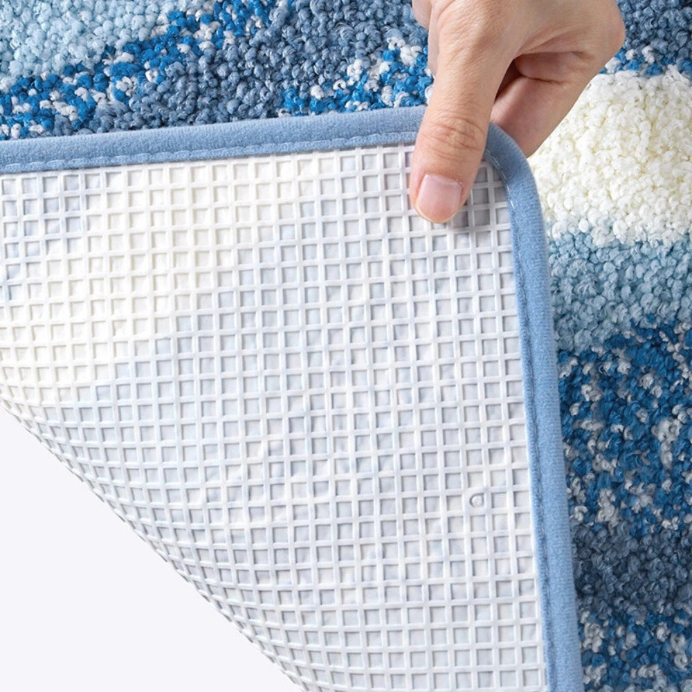 Close-up of a textured rug with a hand lifting a corner, revealing a grid pattern underneath.