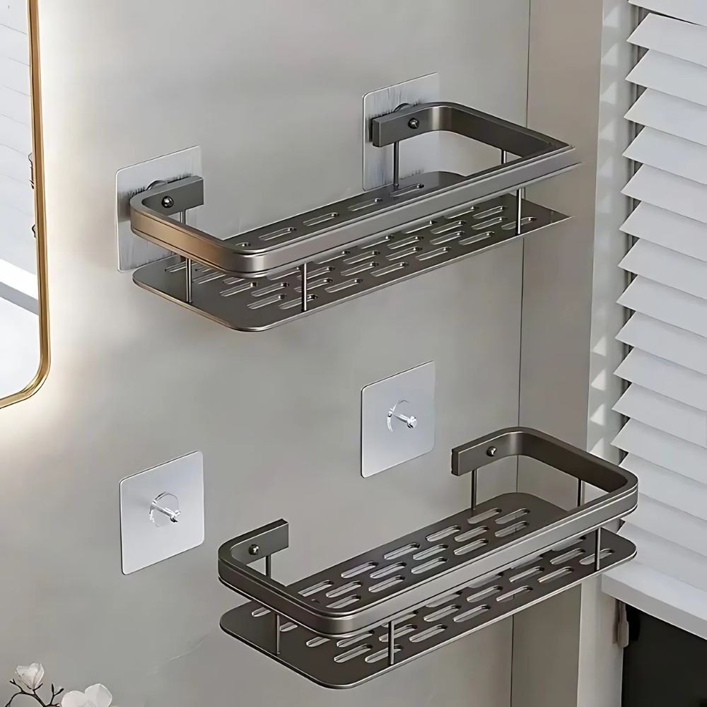 Two metallic wall-mounted shelves on a bathroom wall.